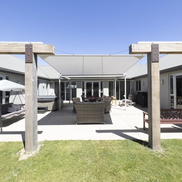 Cool Awnings retractable shade sail providing modern, adjustable shade for outdoor living spaces.