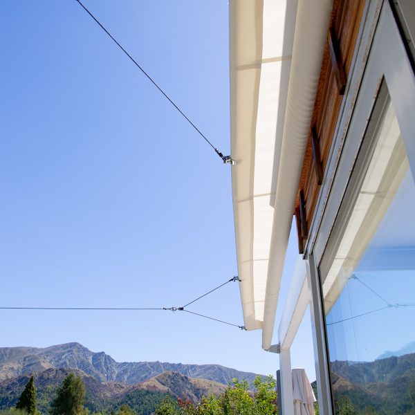 Cool Awnings retractable shade sail, enhancing patios and decks with flexible coverage from sun or rain.