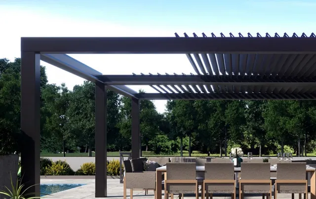 Outdoor patio with automated retractable louvres by Cool Awnings, providing sun control and modern style.