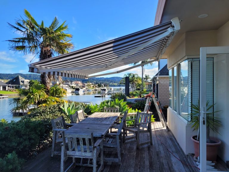 A striped brown and white Helio Shade cassette awning installed by Cool Awnings, providing stylish retractable shade.